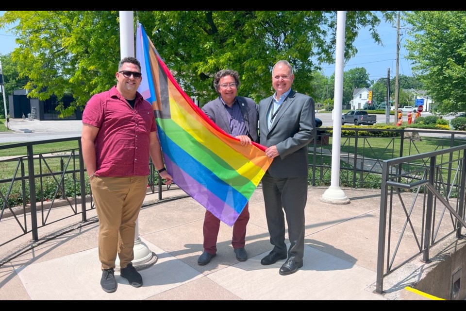 Kyle Miller from Pride Niagara, Lord Mayor Gary Zalepa and interim NOTL CAO Bruce Zvaniga get set to raise the Pride flag at town hall Monday. 