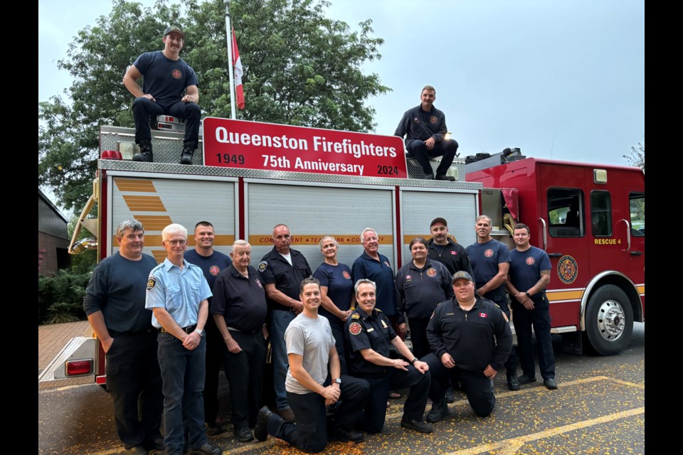 Queenston fire station members and retirees: Spencer Glass, Aaron Oppenlaender (top); standing (l-r) Peter Cox, Ken Hernder (retired),  Alex Ruddy, Jake Redikop (retired), Alan Bilinsky (retired) Deralynn Mackenzie, Colin Dodd (retired) Frank Digweed, Lieutenant Tanner Ferguson, Captain Rob Glass, Braeden Bilinsky; and kneeling, recruit Joe Vrbanek,  District Chief Sylvain Brillon, Assistant District Chief Dylan Skubel.