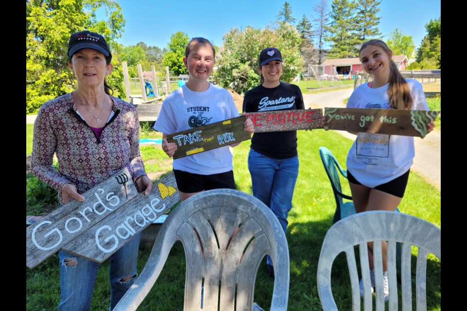 Shari Hartwick, Taylor Carr, Maia Pavone and Natalia Poutsoungas made some signs for Red Roof Retreat.