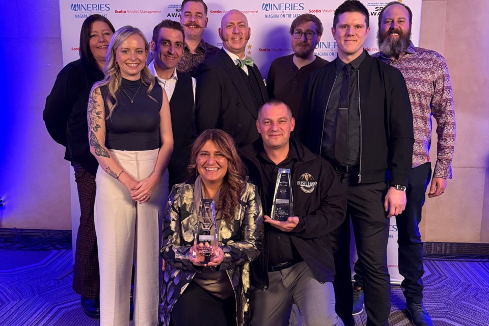 Jovie Joki with her team from the Irish Harp, after being presented with two awards.