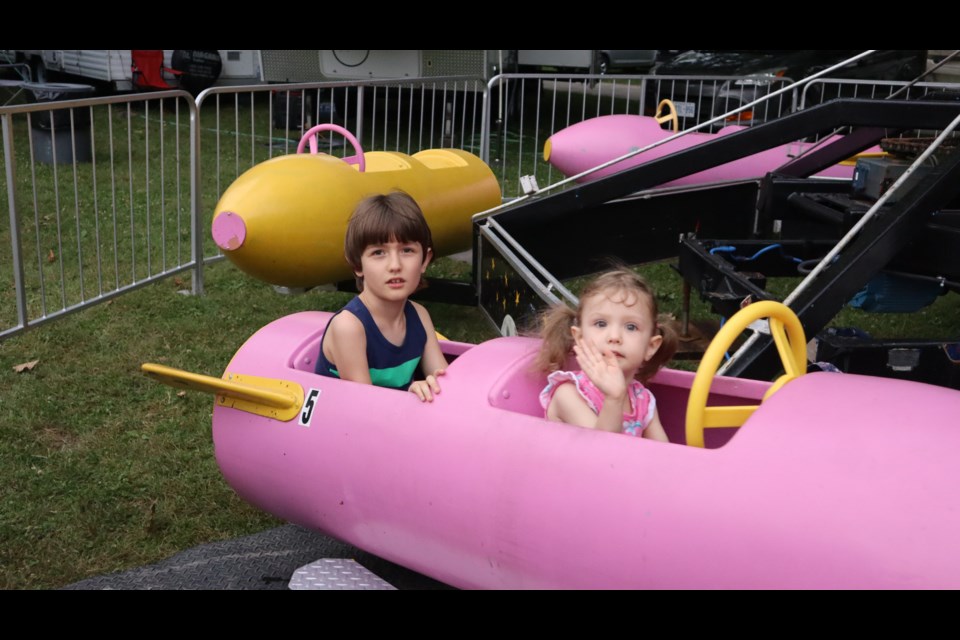 Jasper and Talia Graves enjoying a ride on a rocket