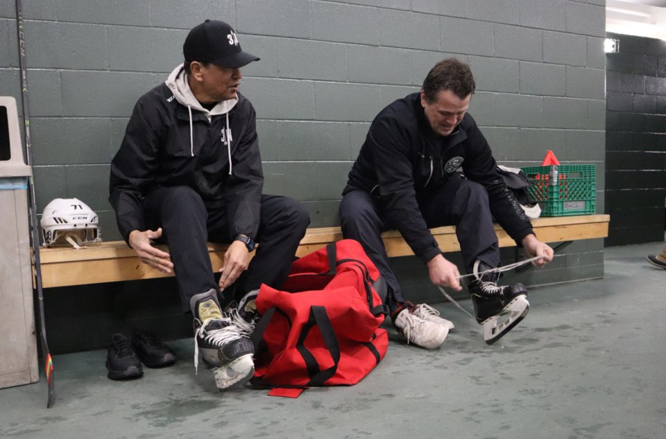 ted-nolan-wolves-ted-and-mike-lacing-up