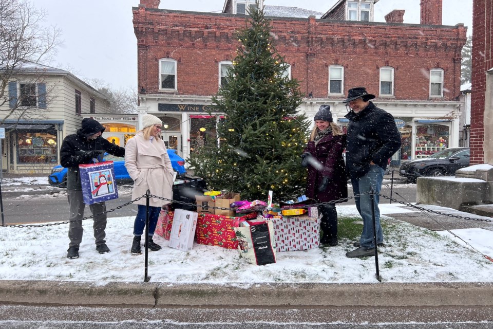 Legion president Al Howse, NOTL Library Community Engagement Coordinator  Debbie Krause, NOTL Museum CEO/Curator Sarah Kaufman and town councillor, Erwin Wiens, stand in front of gifts donated to the Town and community partners' Tommy's Holiday gift drive. | Sharon Burns