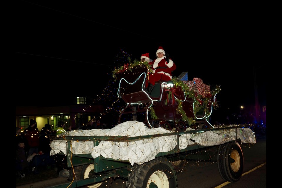  Always the hightlight of the Tractor Parade through Virgil, Santa appears.