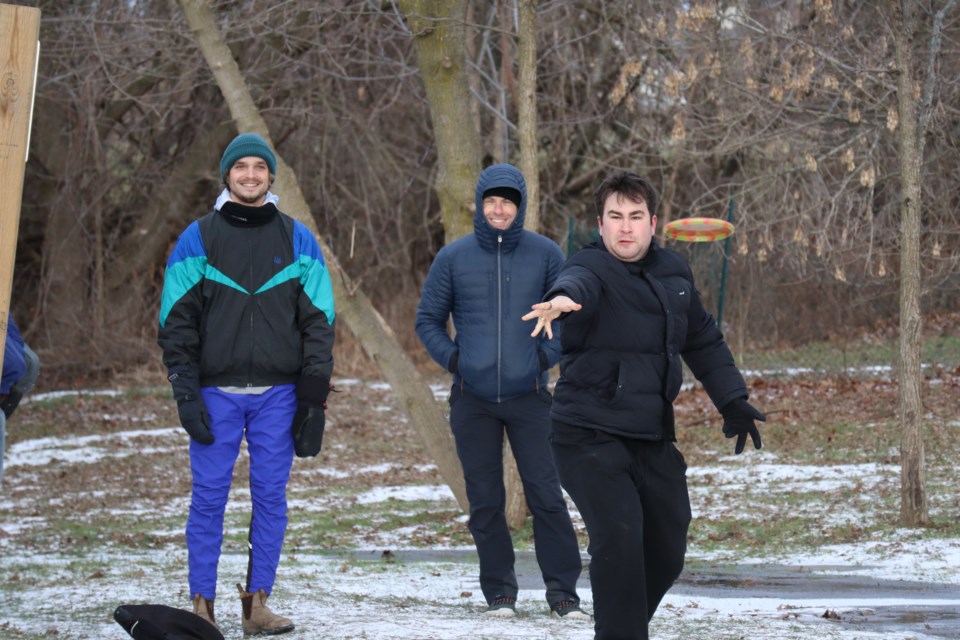 Ben Simmonds and Paul Lalonde watch as Max Schiff-Malins launces a disc. 