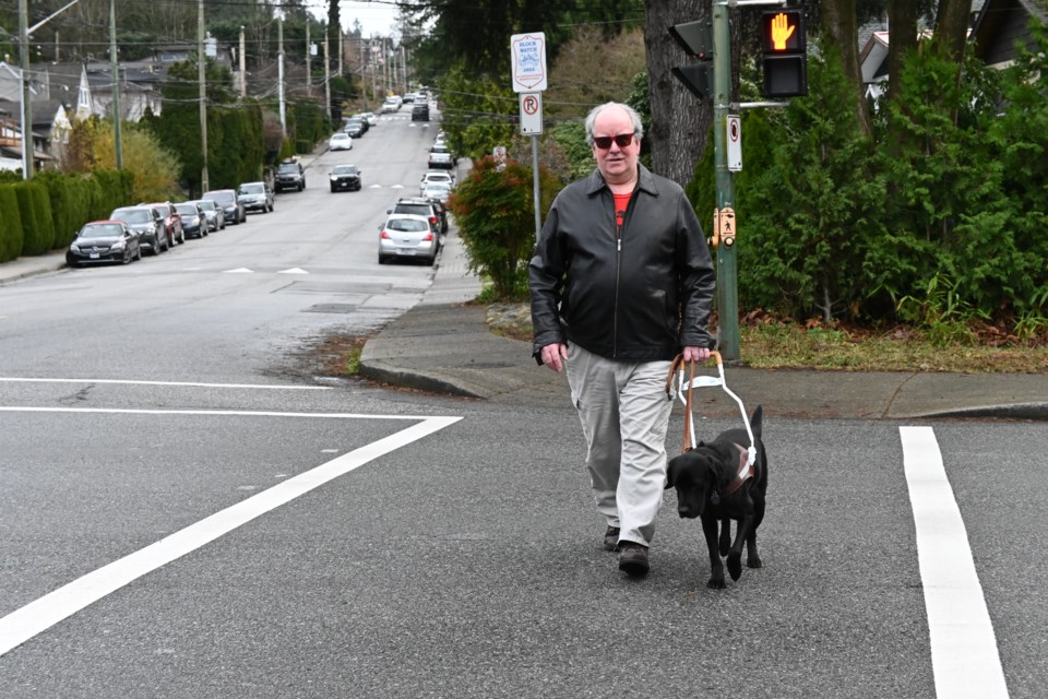 David Brun crosses the intersection of 28th Street West and Westview Drive in North Vancouver with his guide dog, Nadia. | Abby Luciano / North Shore News 