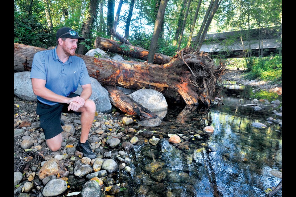 North Shore Streamkeepers president Keegan Cassidy looks over recently completed habitat improvements in lower Mosquito Creek. | Paul McGrath / North Shore News
