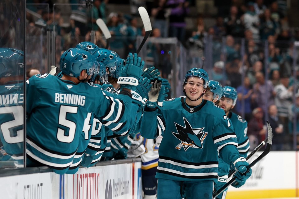 Macklin Celebrini gets high fives from the Sharks bench after scoring his first goal in professional hockey Thursday night in San Jose, Calif. | @NHLPA / X 