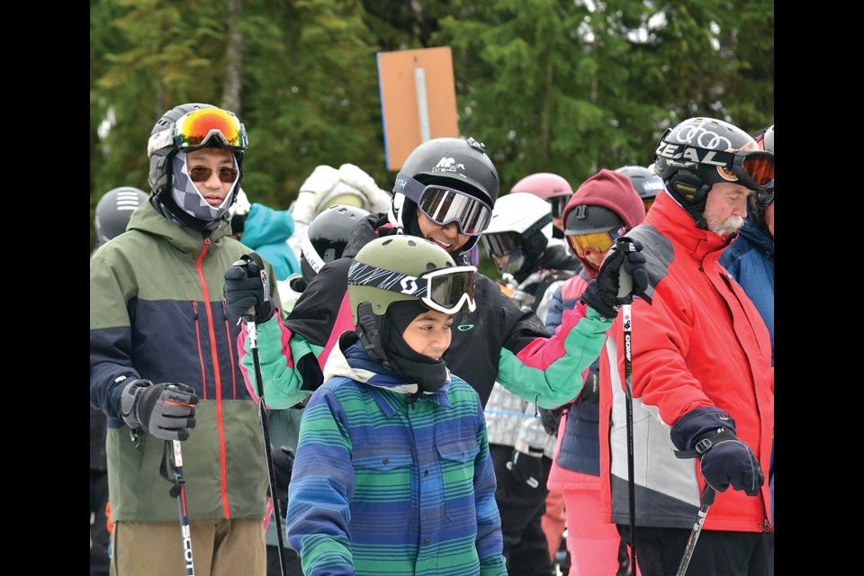 Happy skiers and boarders wait in the lift line at Cypress Mountain on opening day of the season on Friday, Nov. 22. Grouse Mountain is scheduled to open Saturday, Nov 23. Both hills have limited terrain available for riding. | Paul McGrath / North Shore News