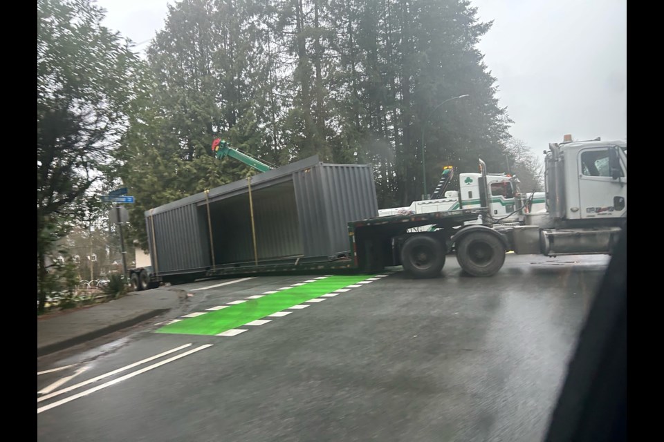 A container spills off a truck bed, blocking traffic on Mount Seymour Parkway and Plymouth Drive in North Vancouver, early Thursday evening. | Anja Knox