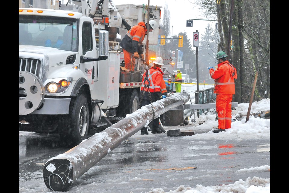 Crews prep a replacement after a falling tree knocked out a 'critical' power pole on Lynn Valley Road just east of Institute Road Friday, Jan. 19. | Paul McGrath / North Shore News