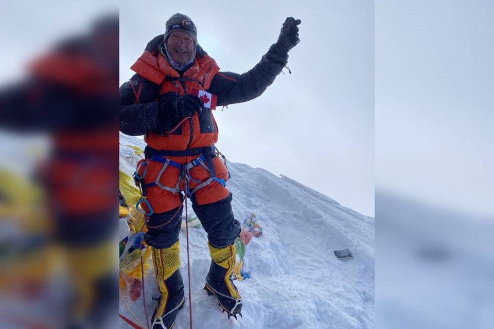 Bruce McAdie holds a small Canadian flag from the summit of Mount Everest at 6:34 a.m. on May 17. | Courtesy of Bruce McAdie 