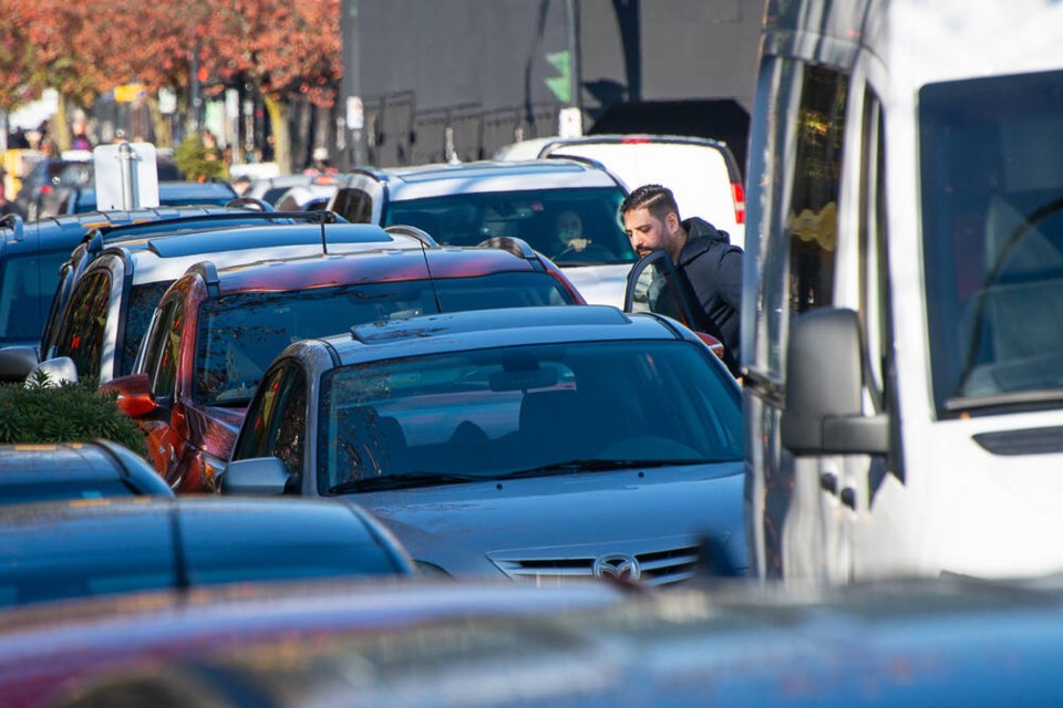 A man opens his car door on Lonsdale Avenue, during the busy lunchtime rush. | Nick Laba / North Shore News files 