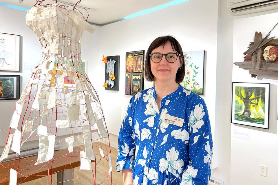 Leigh-Anne Niehaus, community arts supervisor at the Ferry Building Gallery, shows off some of the featured work in the Grad Show 2024 exhibition, featuring pieces submitted by West Vancouver high school students. | Fatemeh Falah / North Shore News 