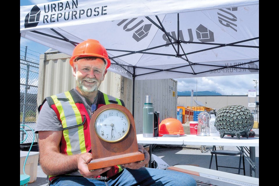 Urban Repurpose’s founder Tom Reissner shows off an antique clock saved in the nick of time before it was dumped at the North Shore Recycling and Waste Centre. | Paul McGrath / North Shore News 