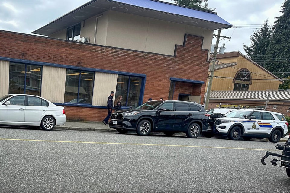 Police and fire investigators gather outside the RBC bank in Edgemont Village on Wednesday morning, after an apparent break and enter attempt at around 2:15 a.m. the same day. | Christie Carrington 