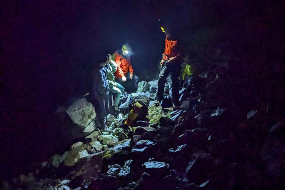 Two lost hikers are met by North Shore Rescue volunteers late Tuesday evening on a steep and slippery section of Hanes Valley. | North Shore Rescue 