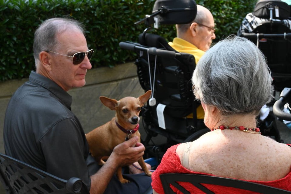 Residents gather for Amica West Vancouver's Doggy Days of Summer event, designed to highlight their pet-friendly policy. | Mina Kerr-Lazenby / North Shore News 