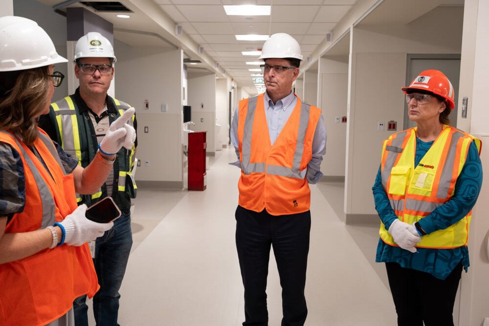 Shelly Fleck – Vancouver Coastal Health’s chief clinical planning officer – explains features of the new Paul Myers Tower, alongside PCL Construction superintendent Grant Blackler, B.C. Health Minister Adrian Dix and North Vancouver-Seymour MLA Susie Chant. | Courtesy of PCL Constructors West Coast 