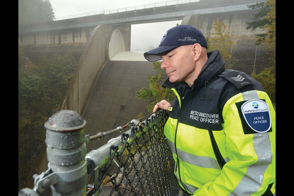 Metro Vancouver peace officer Chris Stier looks over the site of a recent rockslide just below Cleveland Dam in the Capilano Canyon. | Paul McGrath / North Shore ߣ 