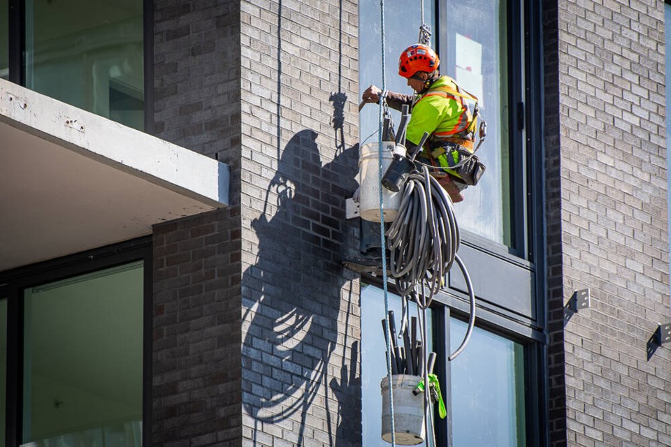 A construction worker helps build a new apartment building in North Vancouver in April 2024. | Nick Laba / North Shore News 