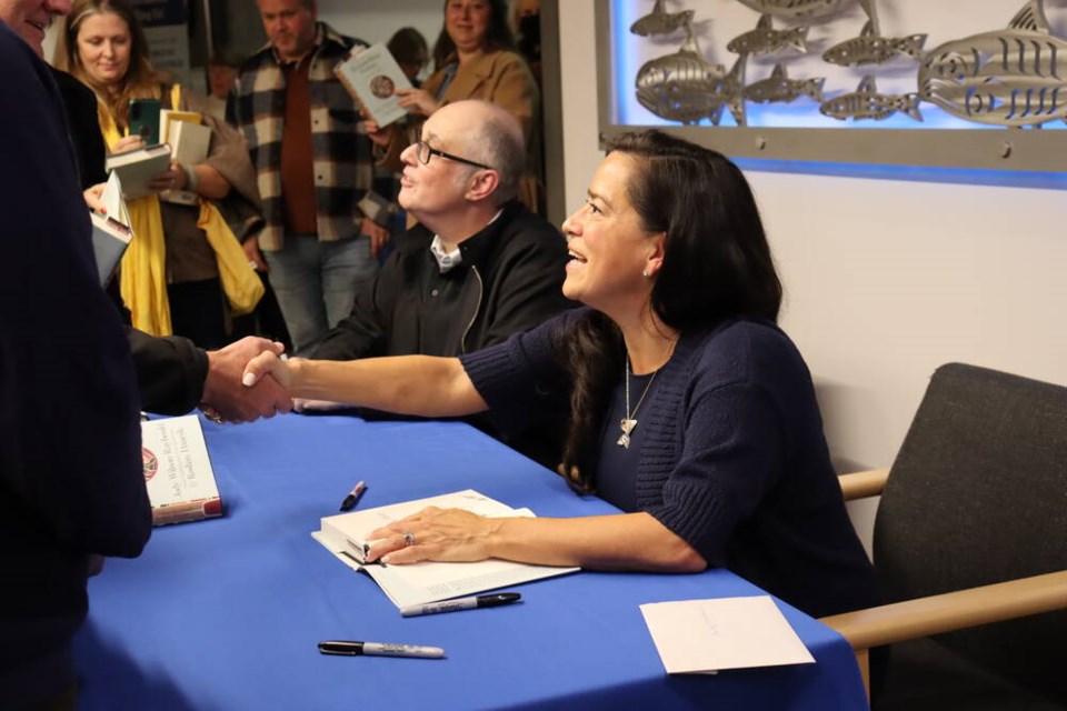 Jody Wilson-Raybould, one of the authors of Reconciling History: A Story of Canada, greets readers at a book launch at West Vancouver Memorial Library Sunday (Oct. 27). | Abby Luciano / North Shore News 