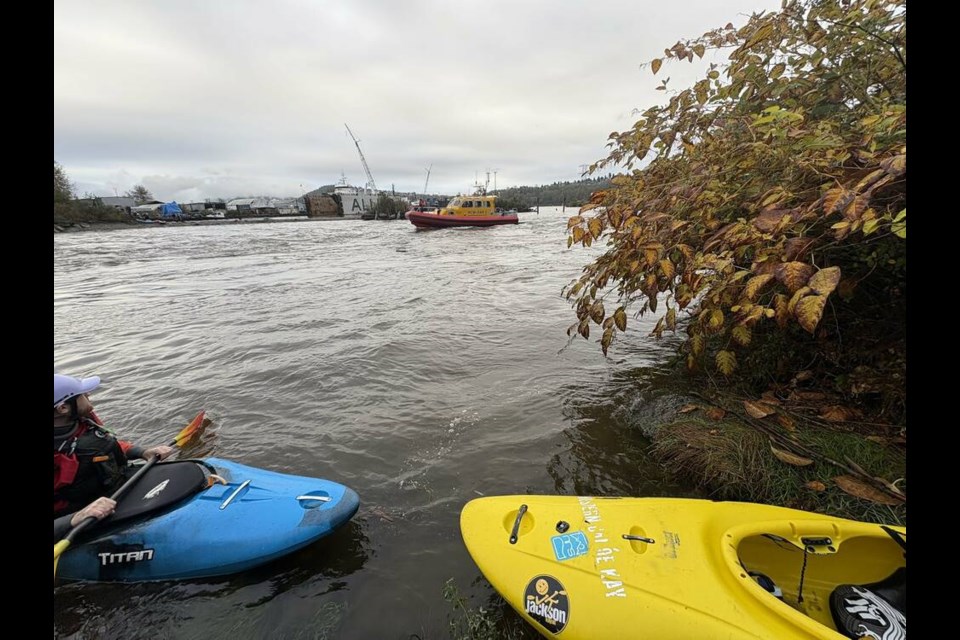 A Royal Canadian Marine Search and Rescue boat helps recover kayakers in distress near the mouth of the Seymour River in the midst of an atmospheric river storm on Sunday, Oct. 20. | North Vancouver RCMP 