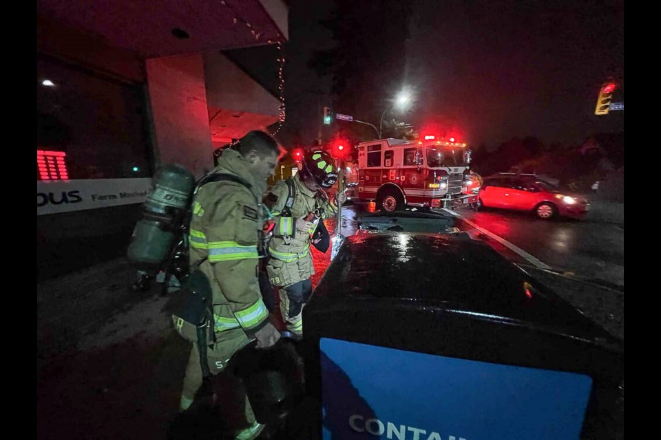 Firefighters respond to a bin that had been set alight in Edgemont Village, Thursday evening. | Pat Bell 