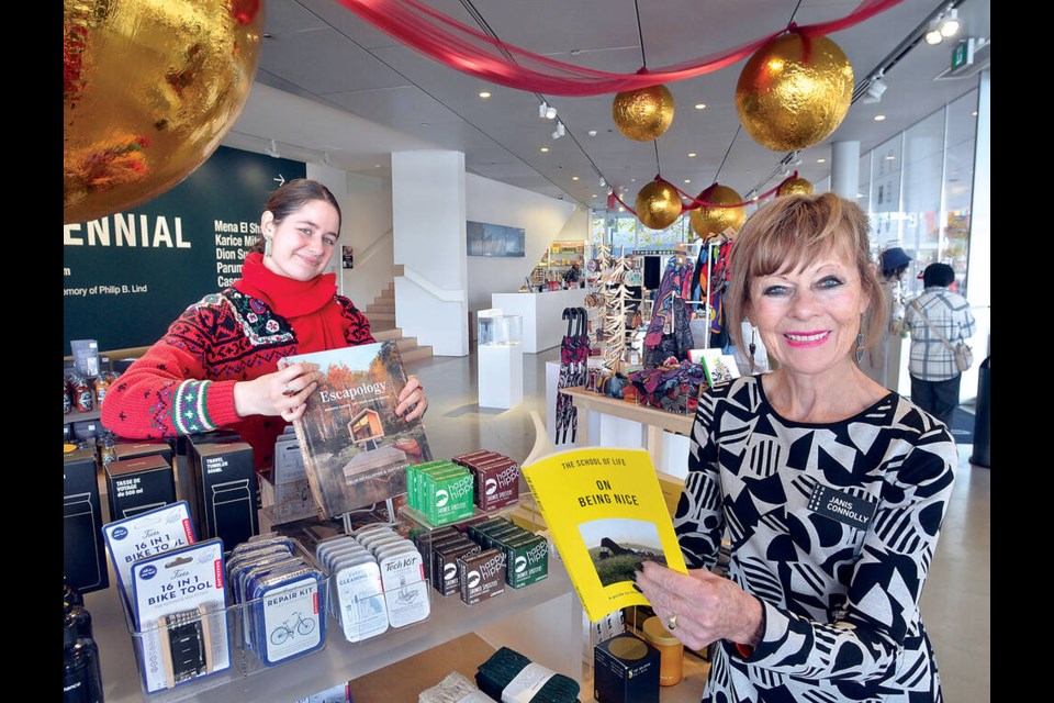 Polygon Gallery guest services staff Bree Castle and Janis Connolly show off some of the gifts available at the gallery's seventh annual holiday shop featuring more than 200 local vendors. | Paul McGrath / North Shore News