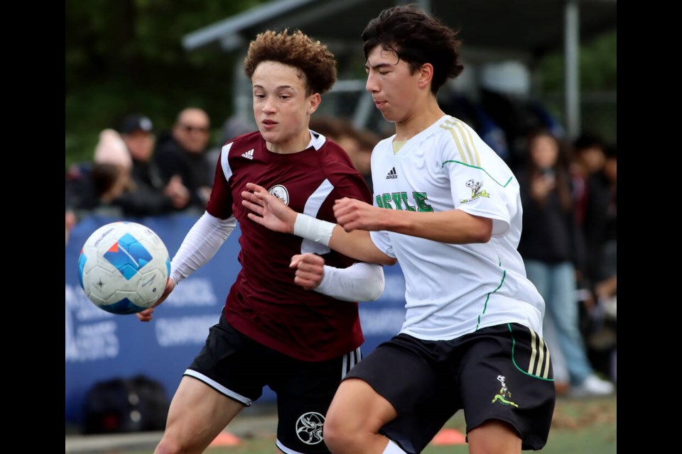 Argyle Pipers defender Ethan McKechnie battles a Burnaby North forward for control of the ball in the first half of the BC boys AAA high school soccer championship match, Saturday at Burnaby Lake Sports Complex. | Mario Bartel / Burnaby Now 