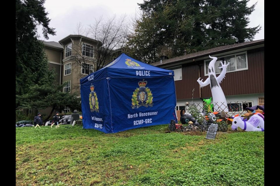 A police tent sits amid Halloween decorations on a lawn in Lynn Valley, Friday afternoon. | North Shore News Staff 