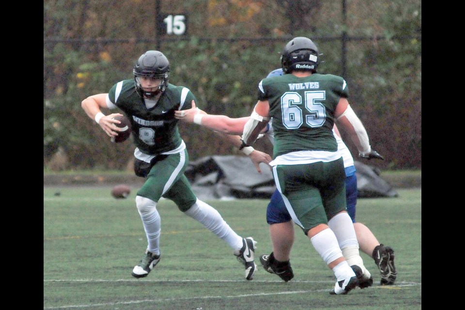 Windsor Wolves quarterback Emmet Ward makes a move in AA action against Parksville’s Ballenas Whalers Oct. 18. The Wolves will play for a provincial AA title Nov. 30 at BC Place. | Paul McGrath / North Shore News 