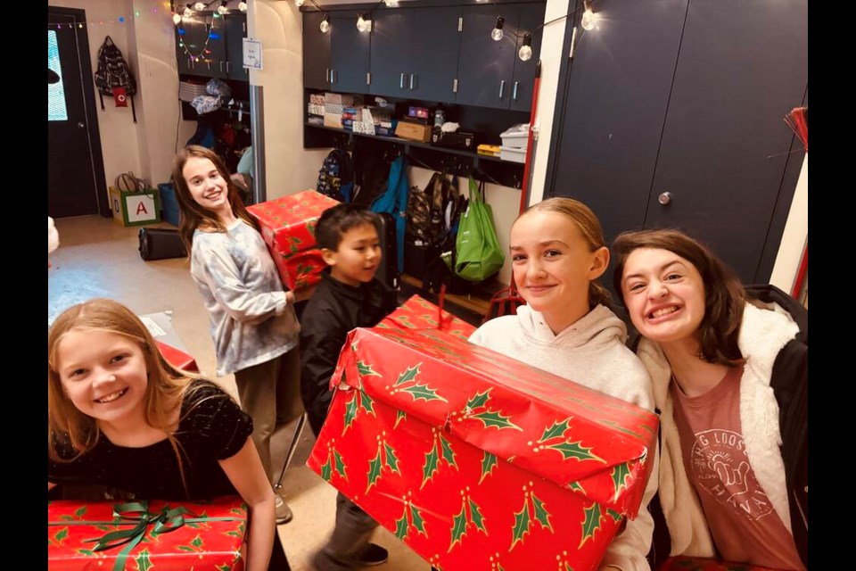 Some of Marta Orellana's Grade 5/6 students hold some of the gift boxes they filled with donations to the North Shore Youth Safe House. | Courtesy of Marta Orellana