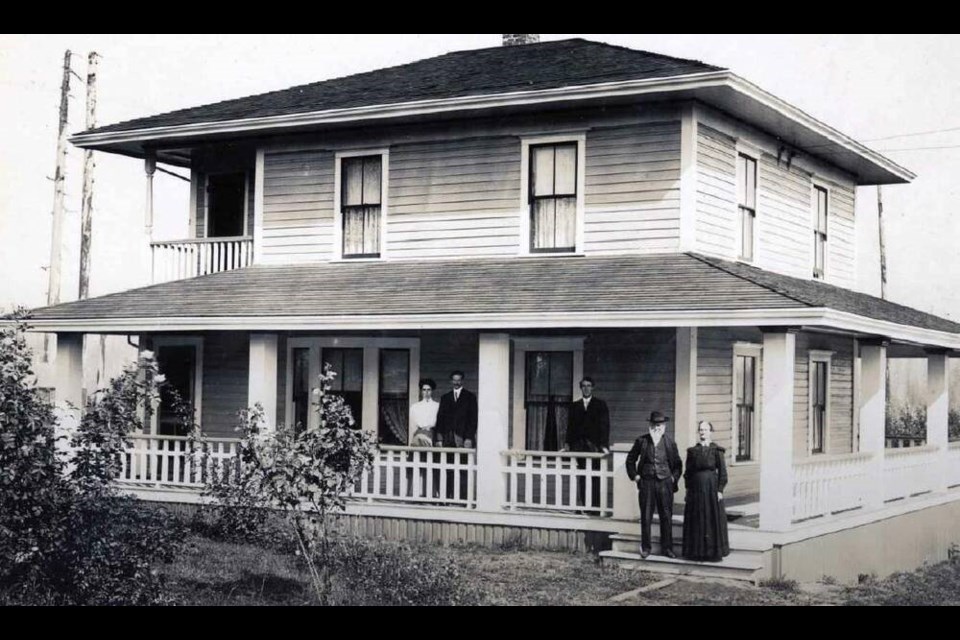 Members of the Cross family stand outside their home after a veranda addition was built in 1911. | NVMA 26-19D-10 