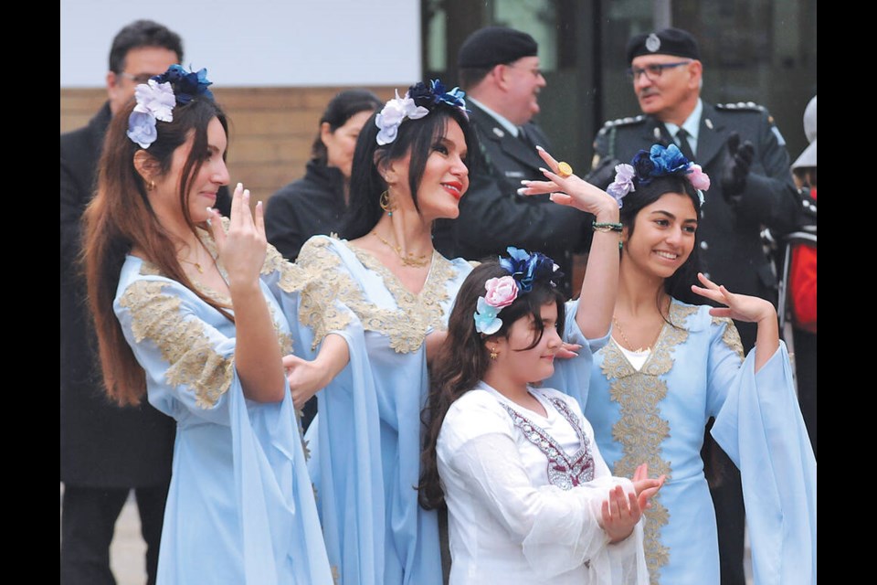 Pooneh Alizadeh (center) leads performers from the AMED Dance Academy in classical Persian dance at the City of North Vancouver Civic Plaza in a celebration of the Persian New Year Nowruz on Friday, March 22, 2024. | Paul McGrath / North Shore News