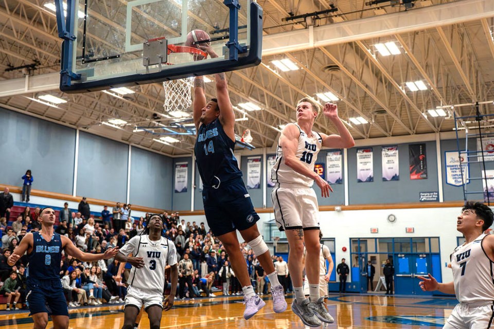 Capilano’s David Featherston Jr. soars for a game-sealing dunk with 19 seconds left in the Pacwest championship final March 1 at Capilano University. | Reese Nowotny/Chris Raeside-Blues Athletics 