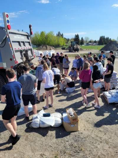 Fort France High School Student pitching in on bagging sand (Photo by Douglas Judson)