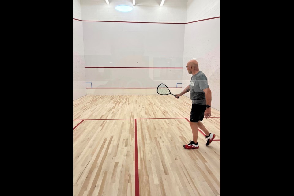 Longtime Sunset Country Squash Club member Bob Tkachuk tests out the new court floors at the Memorial Sports Centre.