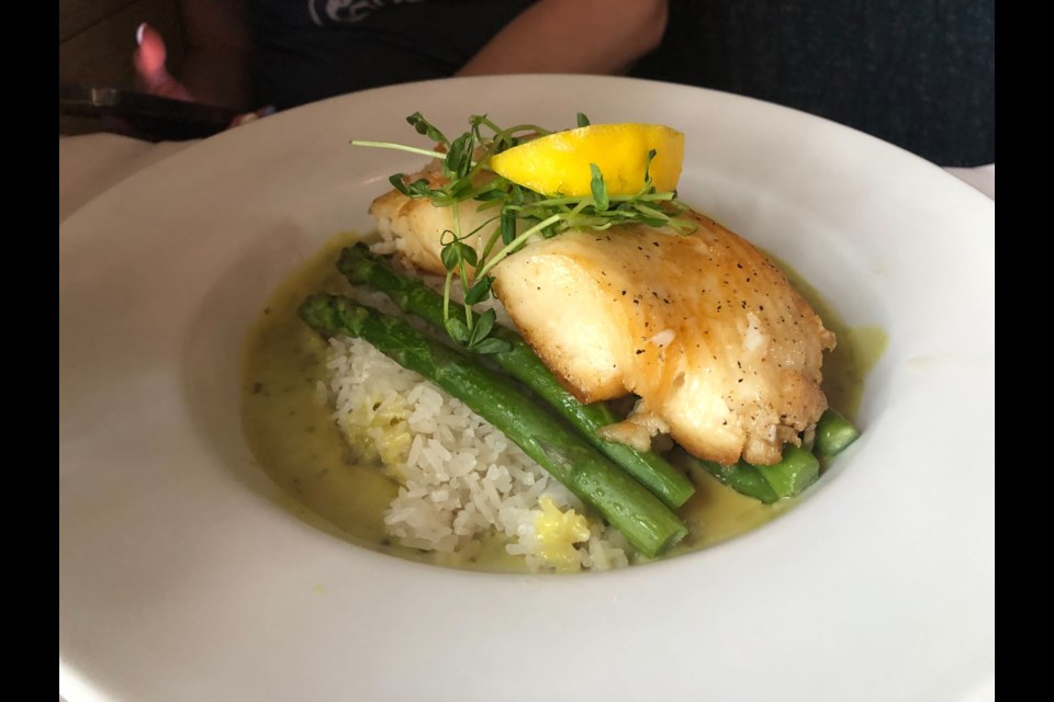 The Captain's Catch meal features halibut with coconut jasmine rice, seasonal vegetable, Thai green curry and lemon brown butter.
