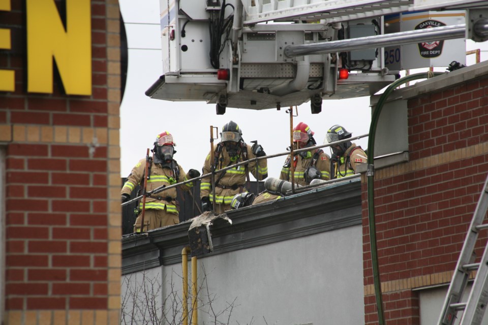 Oakville fire fighters on top of Spoon & Fork in Oakville