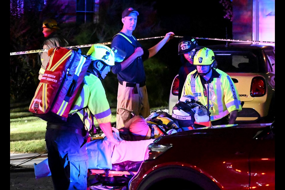 Halton paramedics prepare to transport the third workman rescued from the trench to hospital after being freed by firefighters from a collapsed trench at the rear of a home on Mohawk Road.             