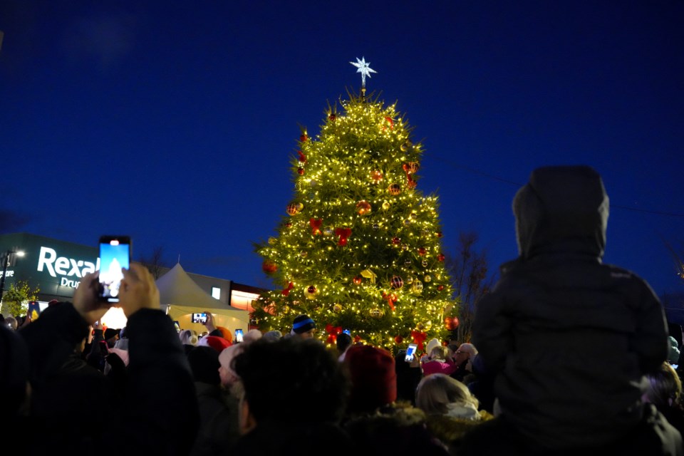 People gather to watch the tree light up at Bronte Market Square.