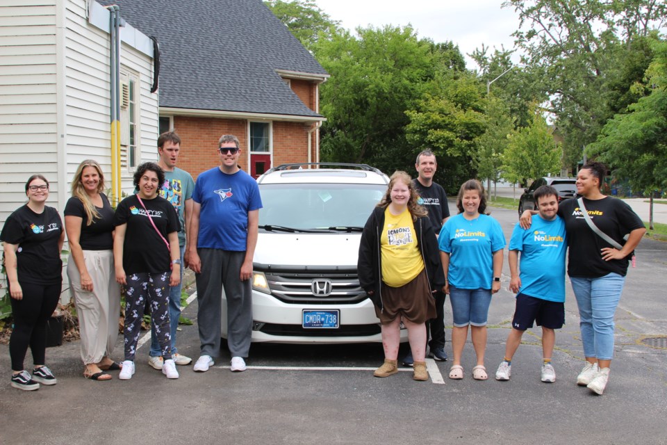 Members of Adults in Motion around their 13-year-old van on Thursday, Aug. 29, 2024.