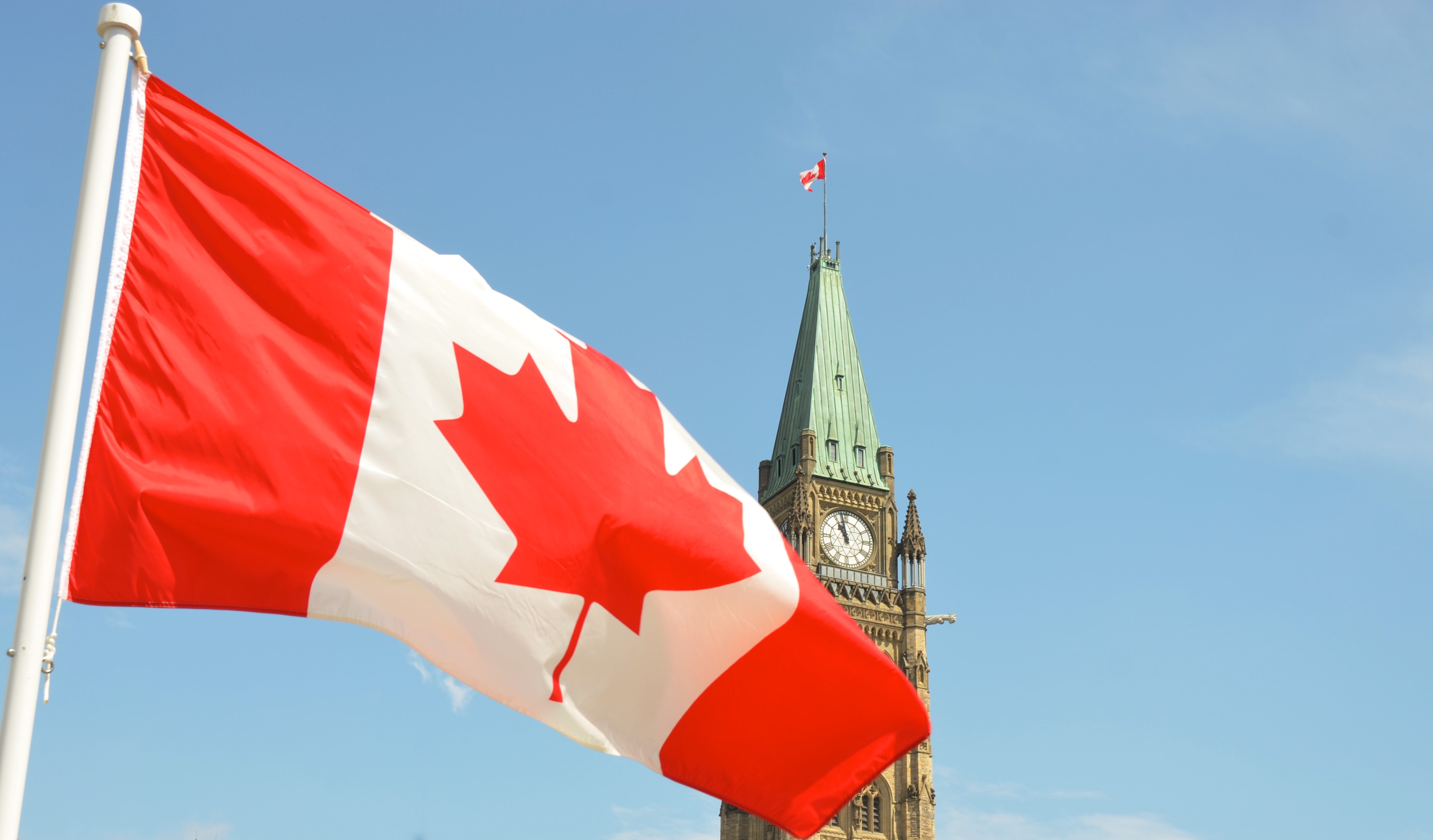 Canadian Flag with Parliament Hill Ottawa | Jason Hafso on Unsplash
