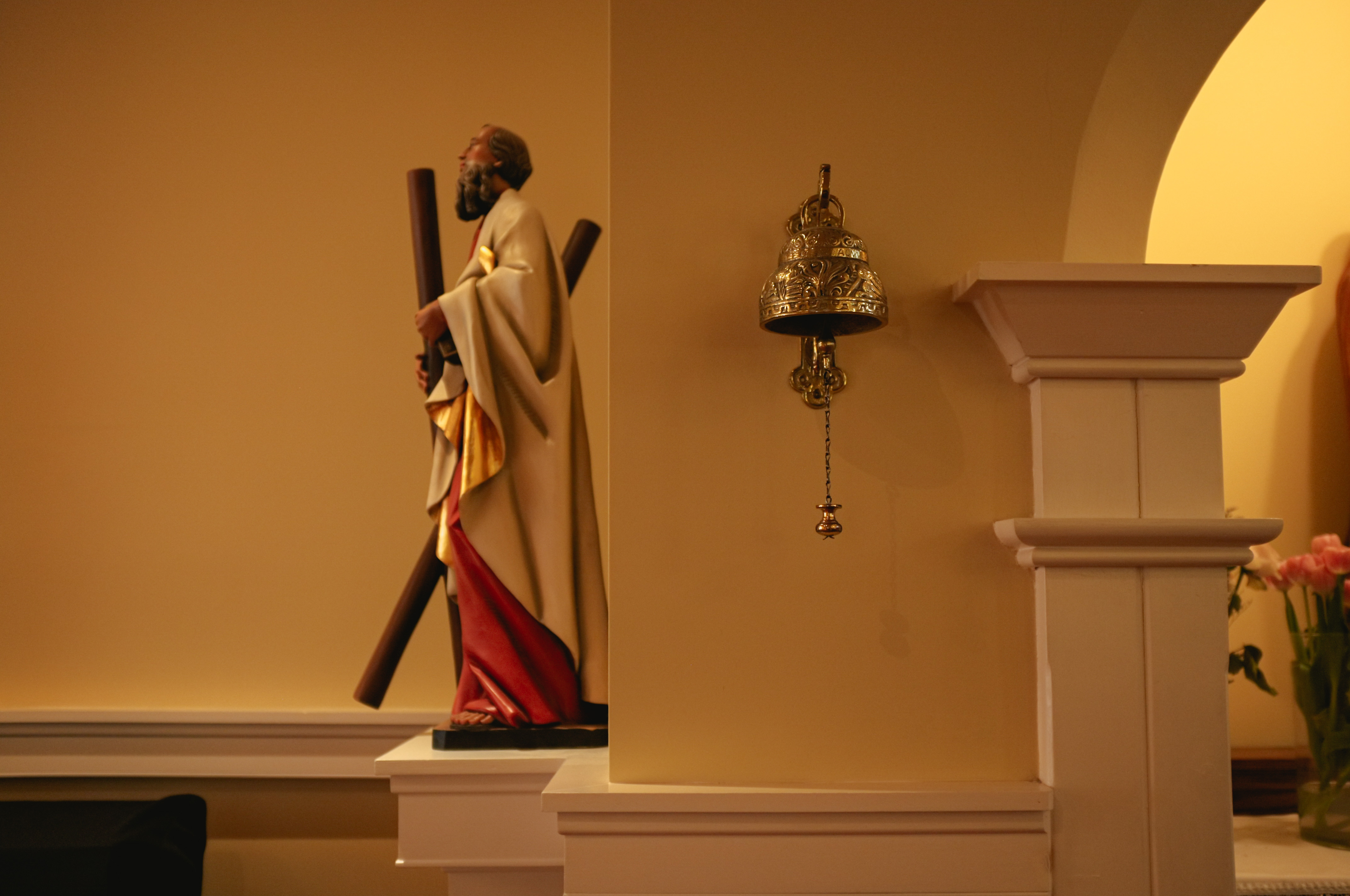 A small bell in a hallway contrasts the large historic bell in the tower of St. Andrew’s church. | Mumin Mian