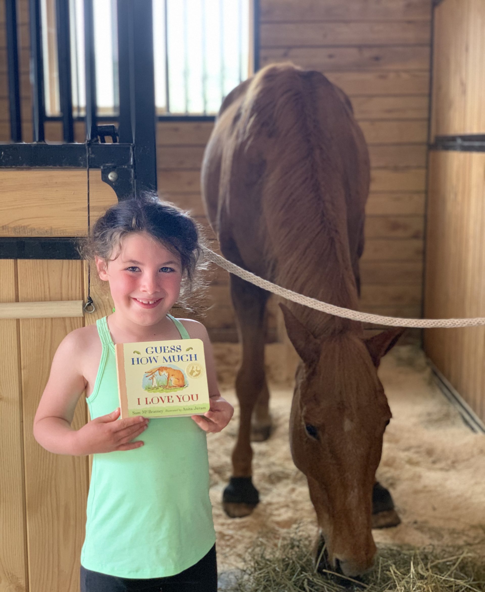 Rachael McMillan reading about horses | Suzanne McMillan