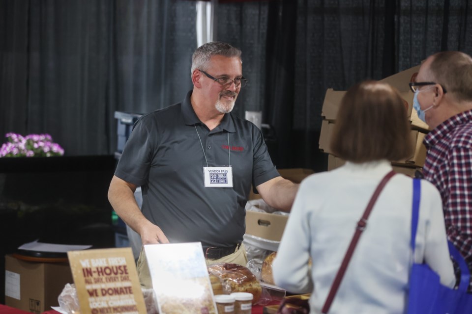 Okotoks COBS Bread owner Lee Hodgins hands out samples at the Okotoks & District Chamber of Commerce Trade and Lifestyle Show on May 6 at the Okotoks Recreation Centre.