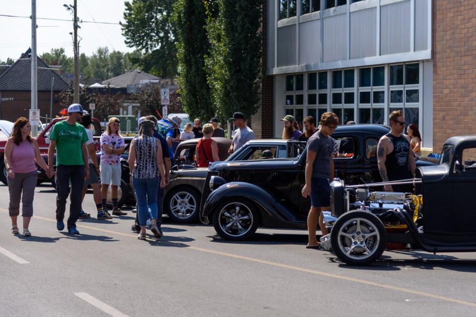 Visitors take in the annual Show and Shine in downtown Okotoks on Aug. 21, 2022. Organizers are moving this year's event to the area around Seaman Stadium, citing a shortage of volunteers. This year's Show and Shine is Aug. 20.