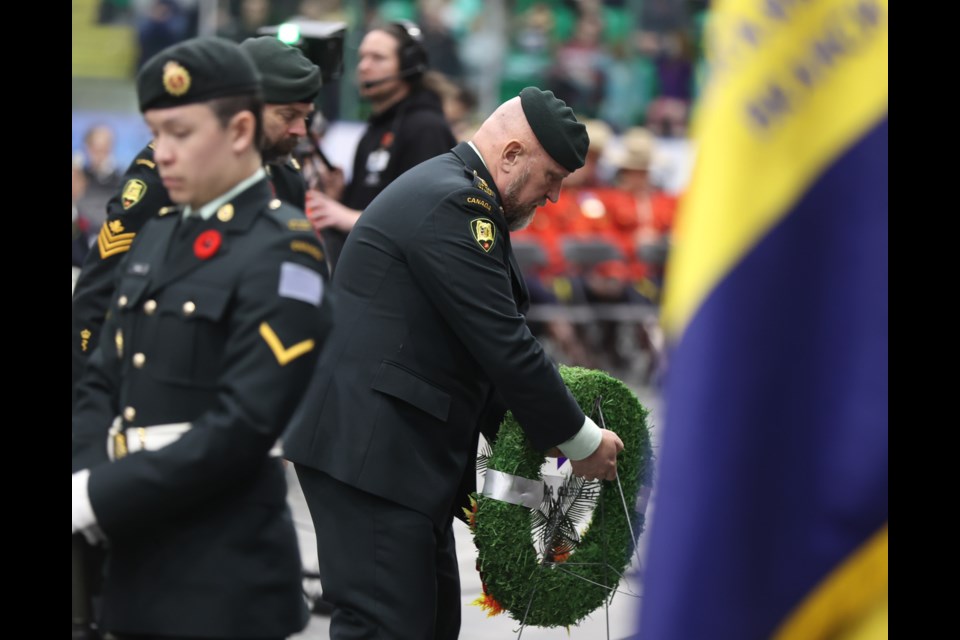 A member of 15 Field Ambulance lays a wreath during the Remembrance Day ceremony at Okotoks Centennial Arena on Nov. 11, 2022.