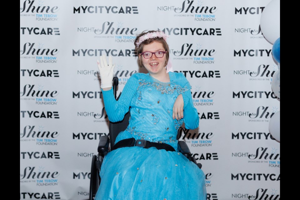 Kianna Thompson poses for the paparazzi on the red carpet for Night to Shine event at the Foothills Centennial Centre on Feb. 10. The event was organized by MyCityCare to give people with special needs and their loved ones a prom/gala night experience, complete with red carpet, limo rides and a banquet dinner.